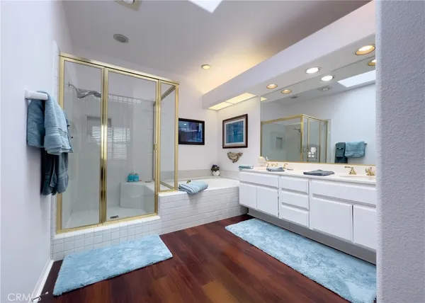 a large bathroom with a large mirror vanity and shower