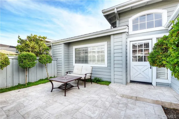 a white bench sitting in front of a house