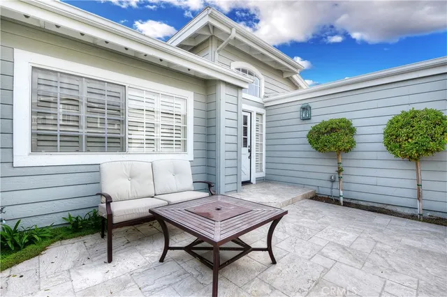 a backyard of a house with barbeque oven table and chairs