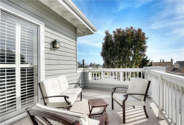 a view of a chairs and table in the balcony