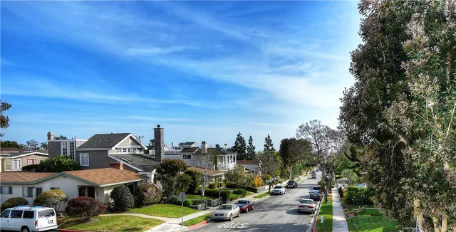 a view of a town with cars parked