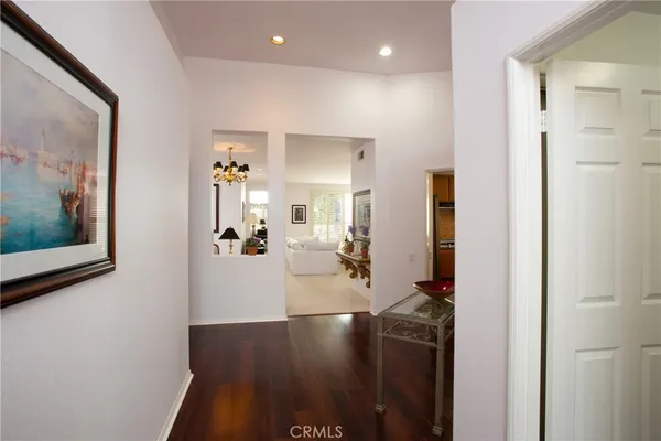 a view of a hallway with dining area and chandelier