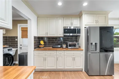 a kitchen with stainless steel appliances kitchen island granite countertop a refrigerator and a stove top oven