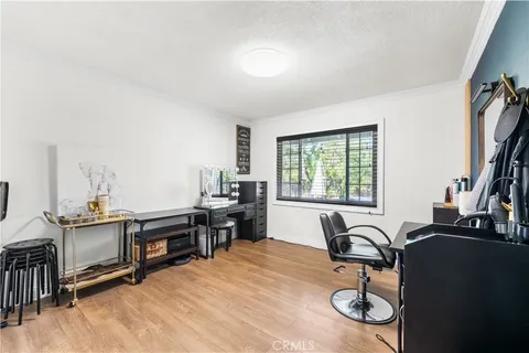 a view of a workspace with furniture and a window