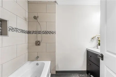 a bathroom with a tub and a sink