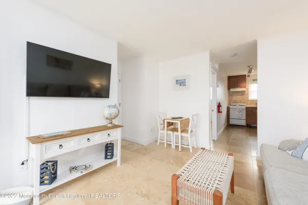 a living room with a flat screen tv on the table and a couch