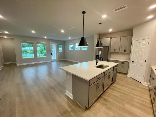 a kitchen with a sink a counter space appliances and a window