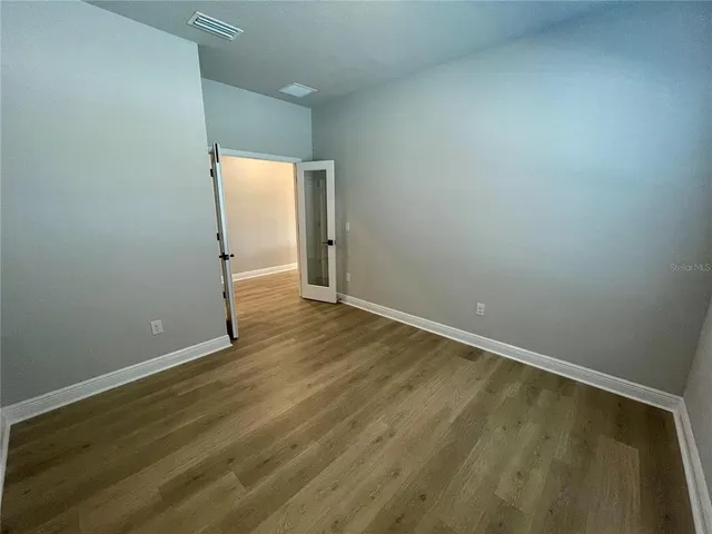 an empty room with wooden floor