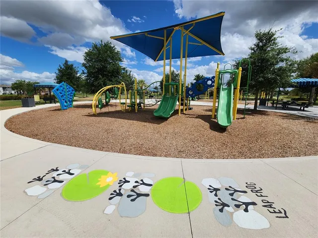 a swimming pool with outdoor seating and yard