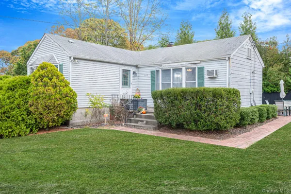a view of a house with a yard and sitting area