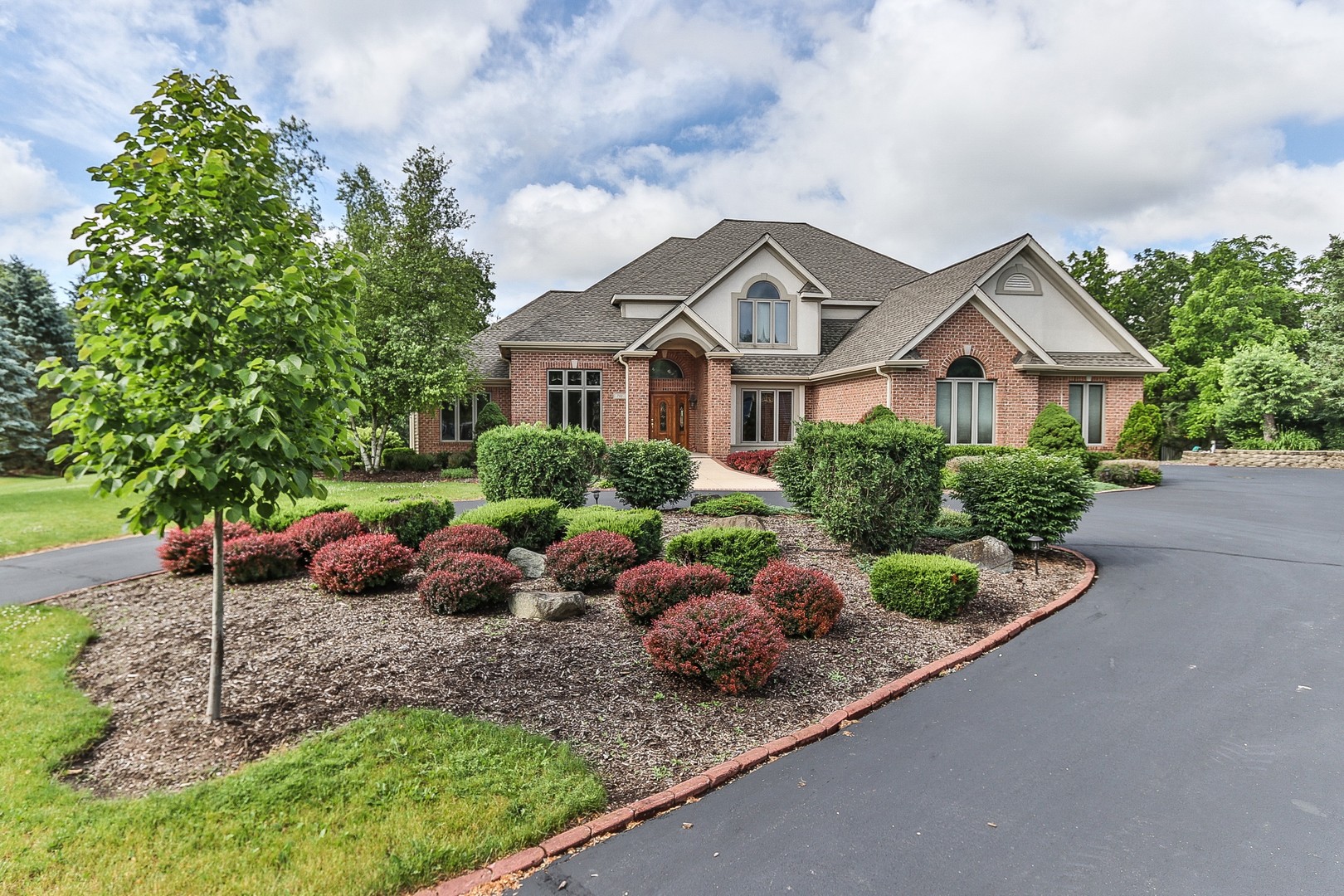 752 Saddle Ridge Crystal Lake, IL 60012 - Photo 2 of 49 a front view of a house with garden