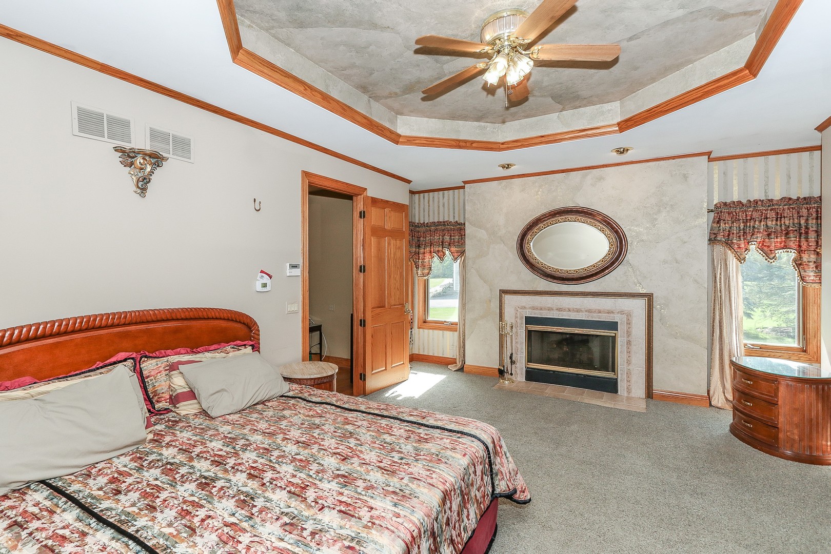 752 Saddle Ridge Crystal Lake, IL 60012 - Photo 19 of 49 a bedroom with a bed and a fireplace