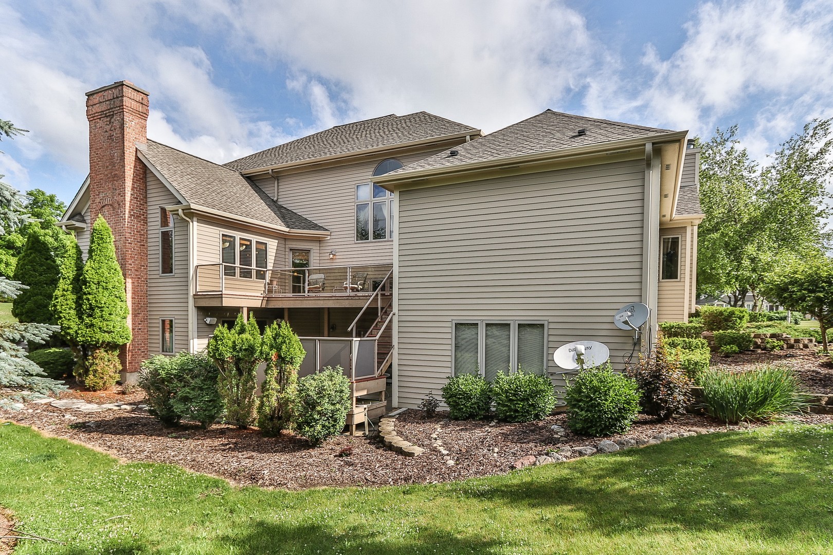 752 Saddle Ridge Crystal Lake, IL 60012 - Photo 44 of 49 a front view of a house with a garden and plants