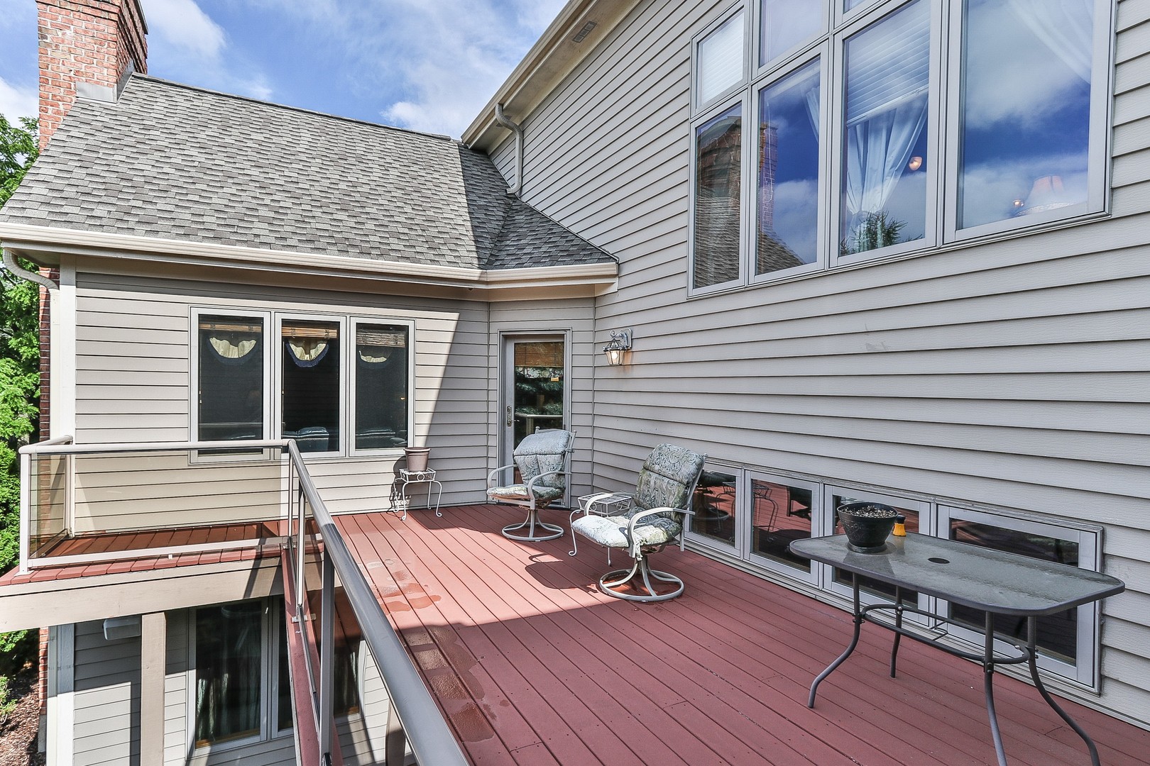 752 Saddle Ridge Crystal Lake, IL 60012 - Photo 46 of 49 a view of a patio with table and chairs with wooden floor and fence