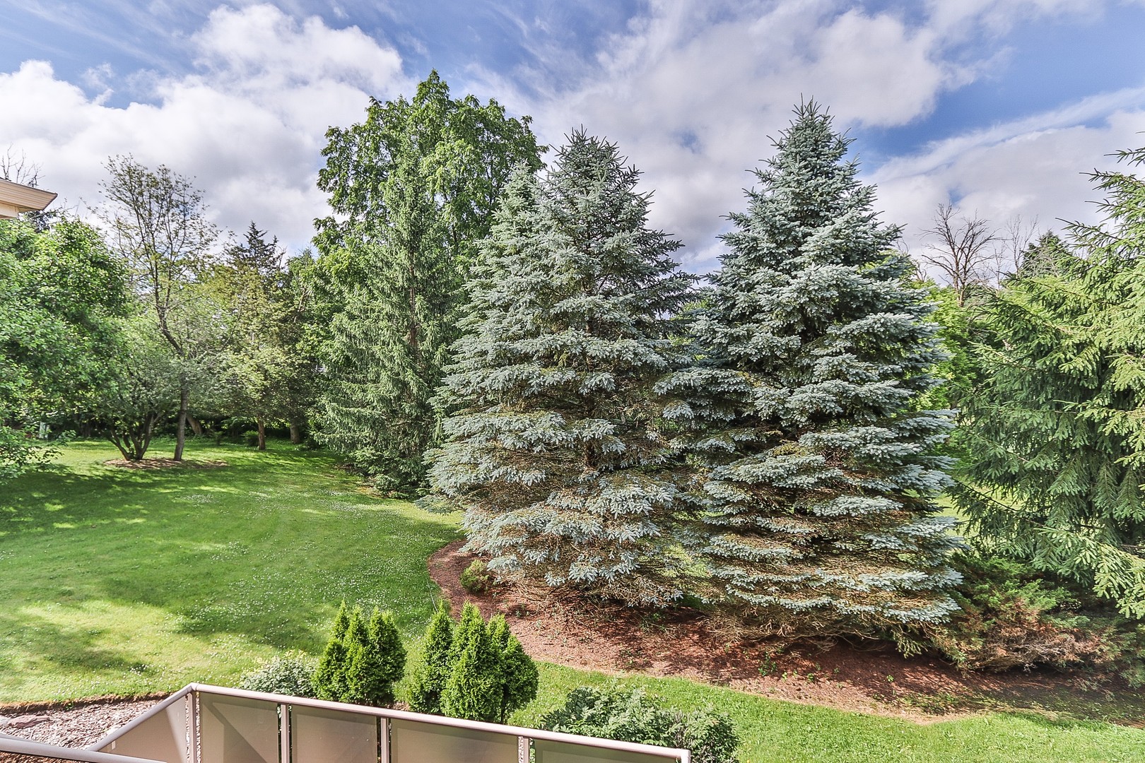 752 Saddle Ridge Crystal Lake, IL 60012 - Photo 47 of 49 a view of a yard with plants and a bench