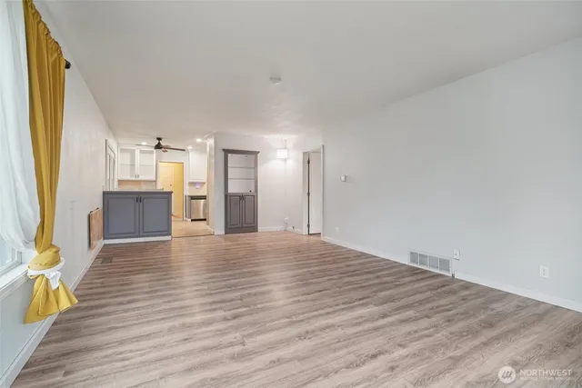 a view of a kitchen with wooden floor and a kitchen