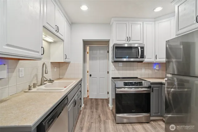 a kitchen with a sink stove and microwave
