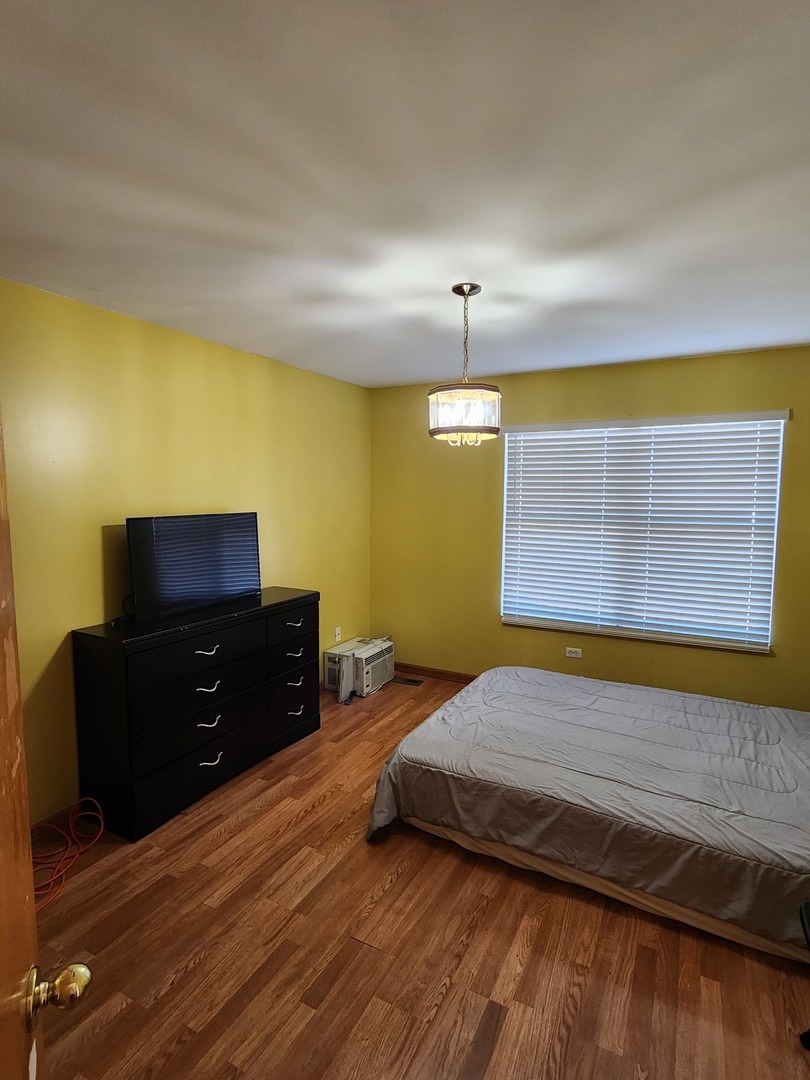 15400 Crocket Lane Markham, IL 60428 - Photo 16 of 19 a bedroom with a bed and wooden floor