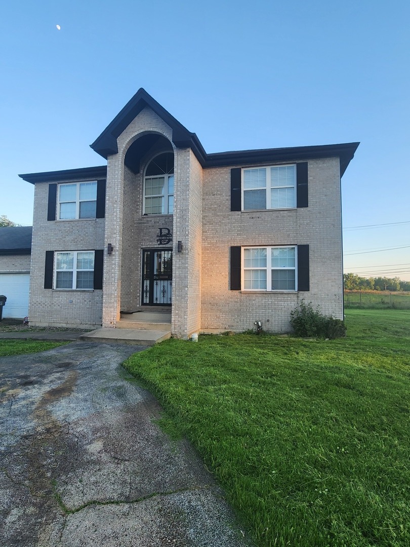 15400 Crocket Lane Markham, IL 60428 - Photo 2 of 19 a front view of a house with garden
