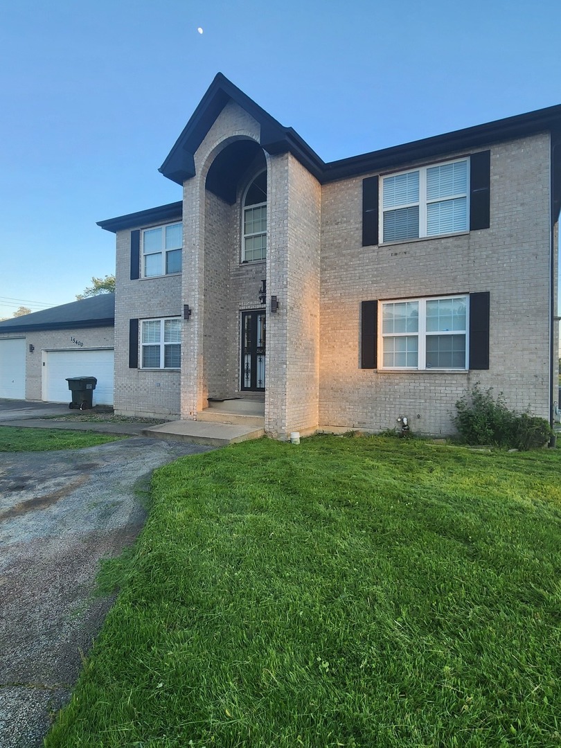 15400 Crocket Lane Markham, IL 60428 - Photo 3 of 19 a front view of a house with a yard