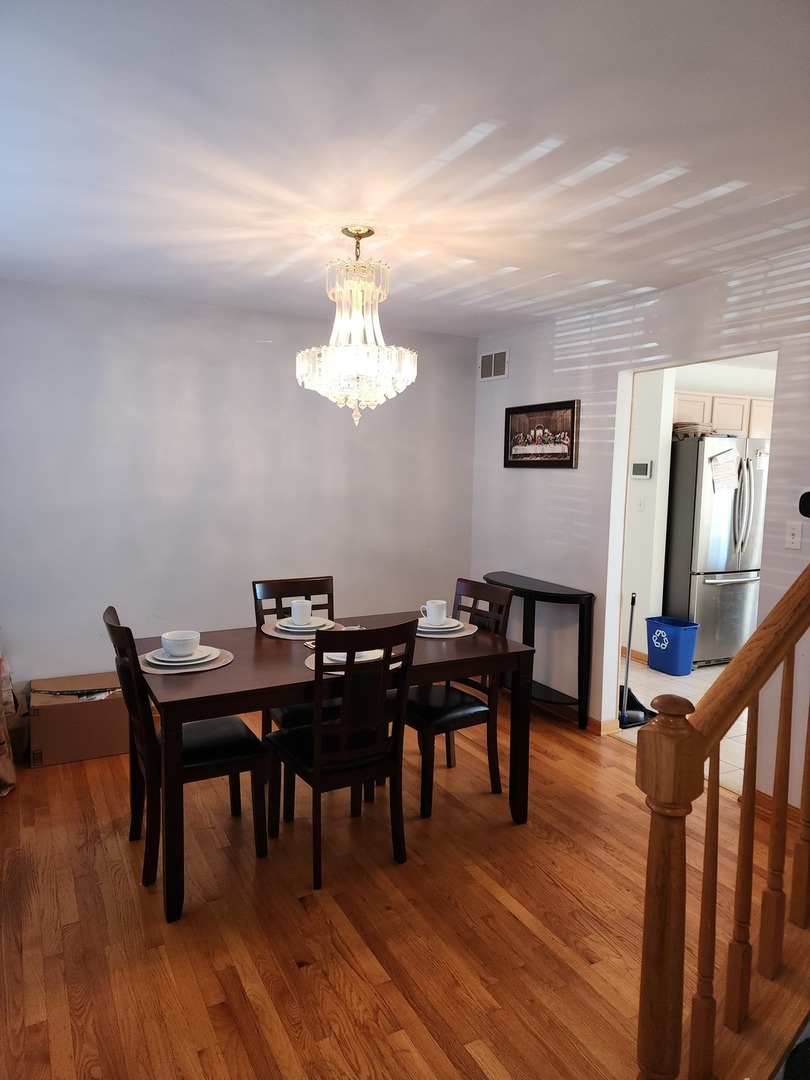 15400 Crocket Lane Markham, IL 60428 - Photo 6 of 19 a view of a dining room with furniture and wooden floor