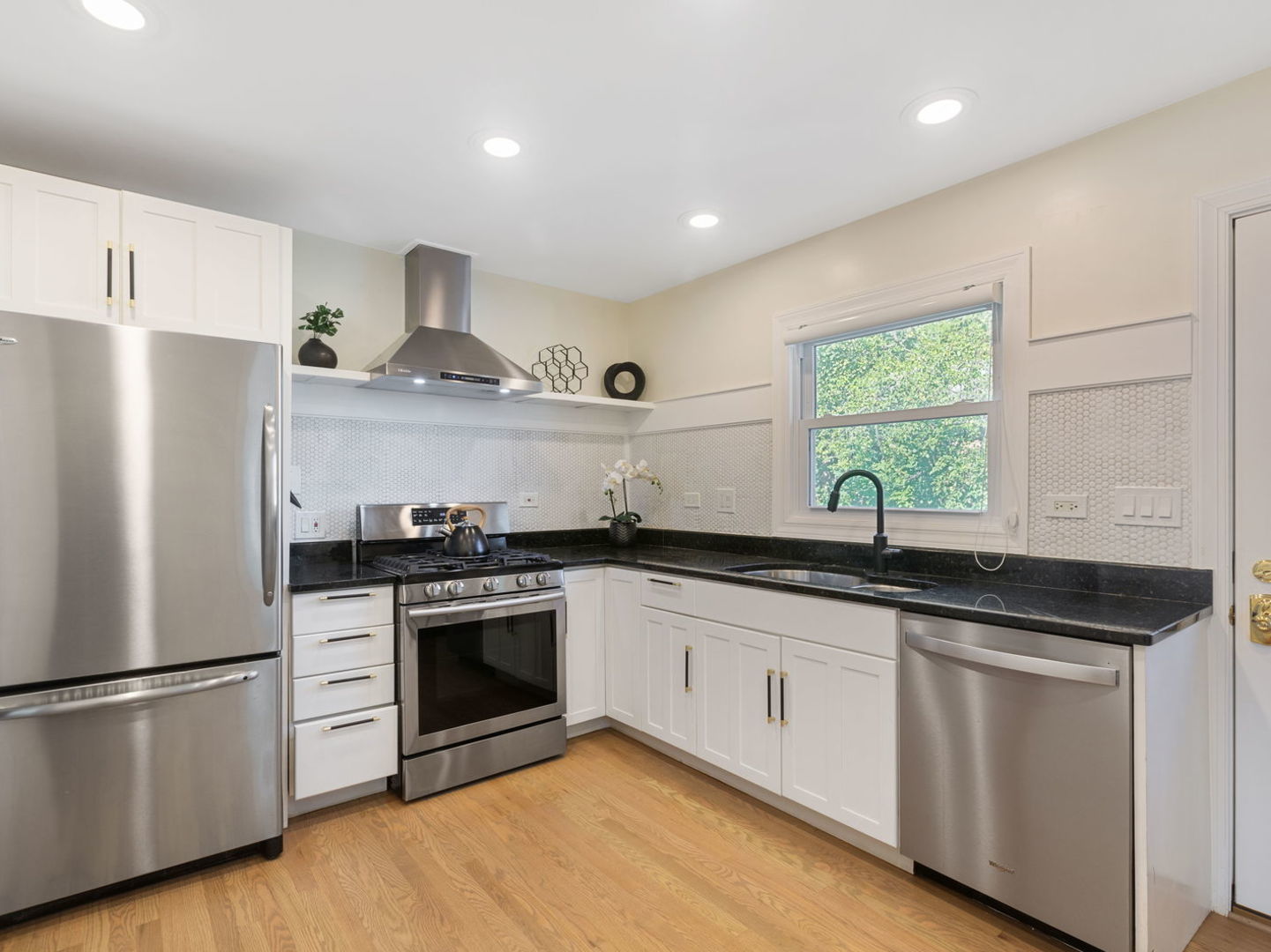 578 Sumac Road Highland Park, IL 60035 - Photo 7 of 28 a kitchen with granite countertop stainless steel appliances a sink cabinets and a window