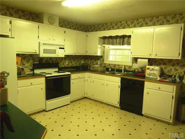 212 Mace Road Mebane, NC 27302 - Photo 3 of 23 Imagine the meals you can prepare in this large kitchen with ample cabinetry and countertops.