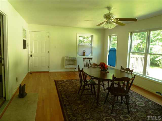 212 Mace Road Mebane, NC 27302 - Photo 8 of 23 Owner added this large light-filled sun room for versatile additional living space. Door leads out to large private deck.