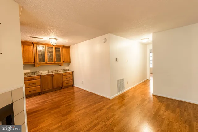a view of a kitchen with a sink and wooden floor