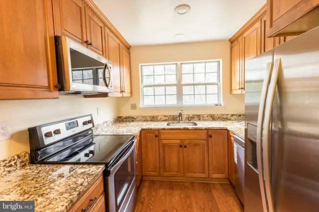 a kitchen with a stove a sink and a refrigerator