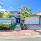 a front view of a house with a yard and a garage