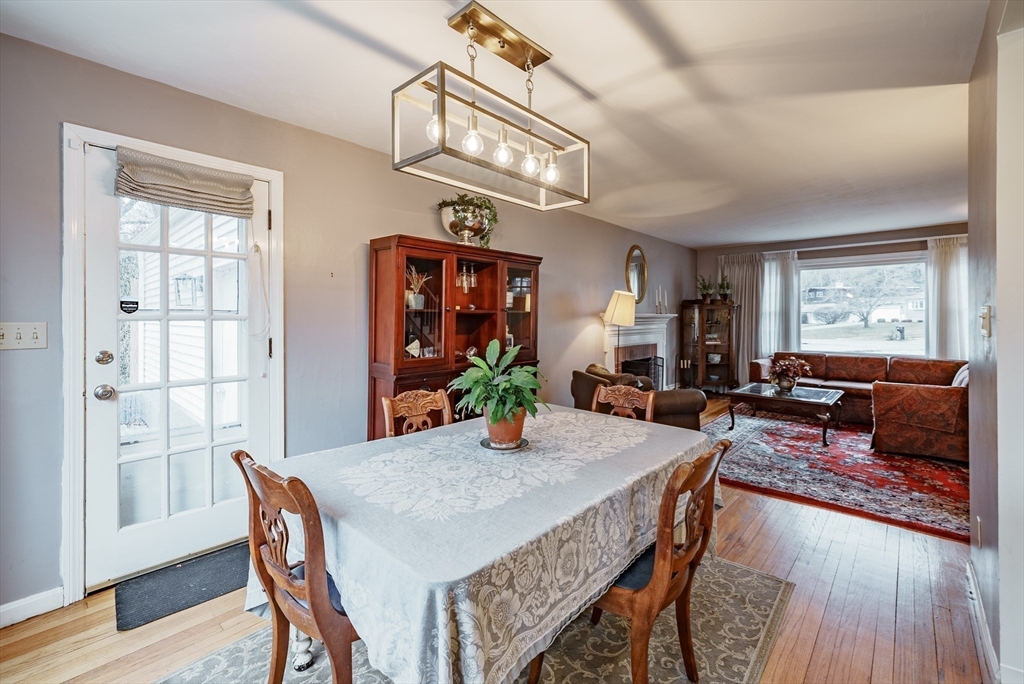 384 Forest Hills Road Springfield, MA 01128 - Photo 11 of 36 a view of a dining room with furniture a chandelier and wooden floor