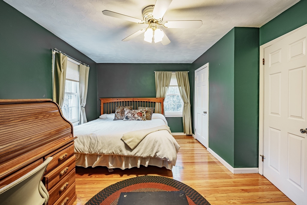 384 Forest Hills Road Springfield, MA 01128 - Photo 17 of 36 a bedroom with a bed and a chandelier