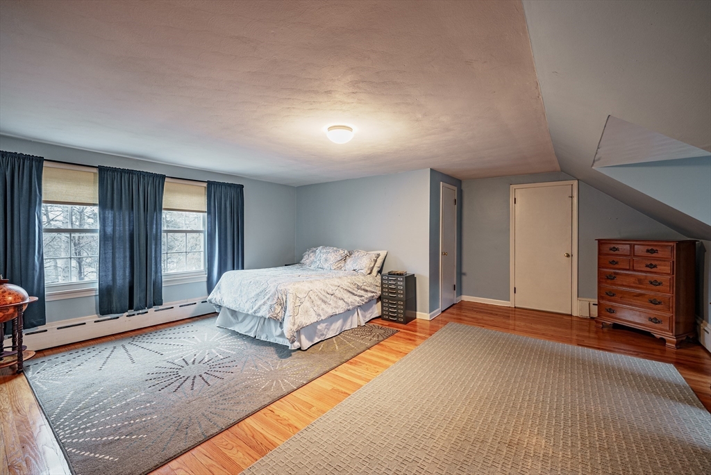 384 Forest Hills Road Springfield, MA 01128 - Photo 22 of 36 a spacious bedroom with a large bed and a window
