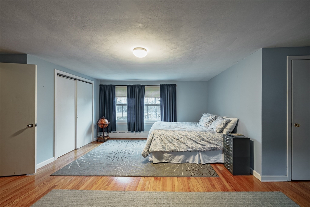 384 Forest Hills Road Springfield, MA 01128 - Photo 23 of 36 a bedroom with a bed and wooden floor