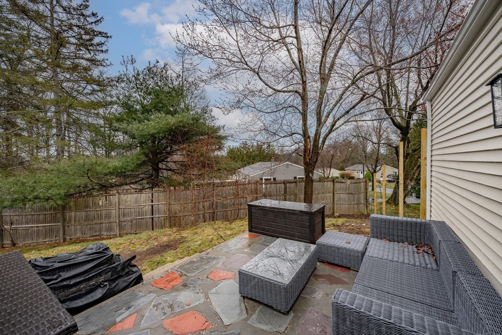 384 Forest Hills Road Springfield, MA 01128 - Photo 26 of 36 a view of a patio with couches and a table and chairs with wooden floor and fence