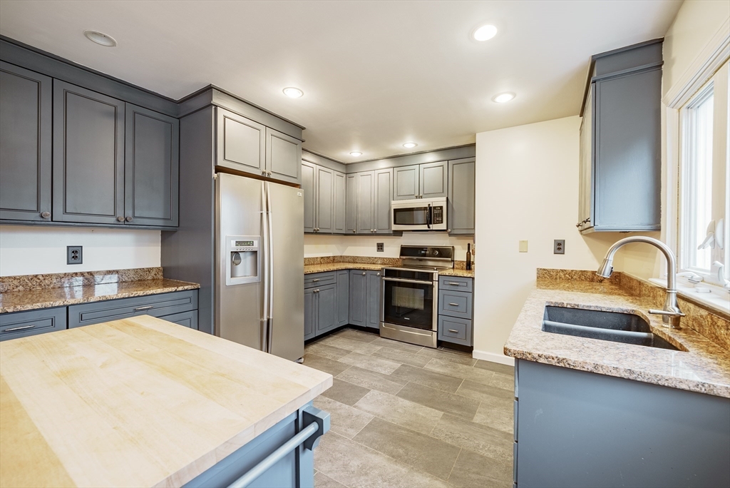 384 Forest Hills Road Springfield, MA 01128 - Photo 7 of 36 a kitchen with stainless steel appliances a refrigerator sink and cabinets