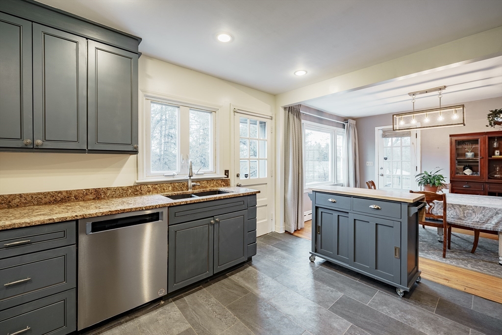 384 Forest Hills Road Springfield, MA 01128 - Photo 8 of 36 a large kitchen with granite countertop a sink and dishwasher a stove with wooden floor