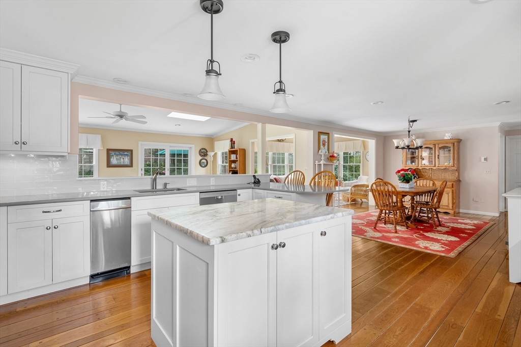 200 Sturbridge Drive Barnstable, MA 02655 - Photo 12 of 39 a kitchen with stainless steel appliances granite countertop a stove and a wooden floors