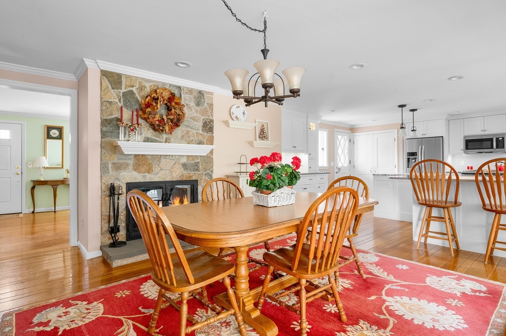 200 Sturbridge Drive Barnstable, MA 02655 - Photo 13 of 39 a dining room with furniture a chandelier and wooden floor