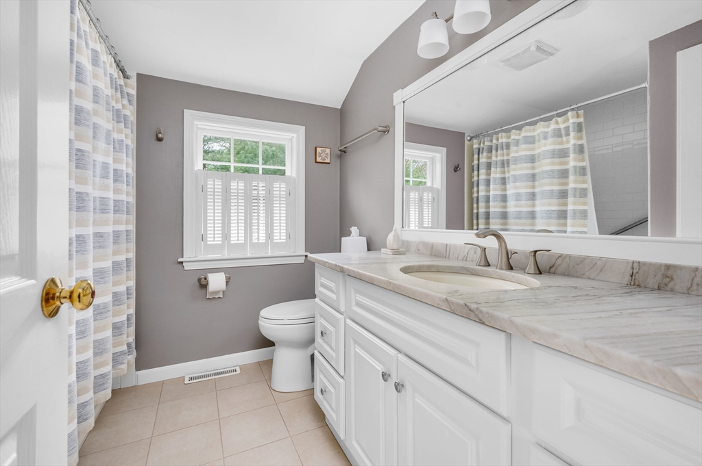 200 Sturbridge Drive Barnstable, MA 02655 - Photo 23 of 39 a bathroom with a granite countertop sink mirror vanity and a toilet