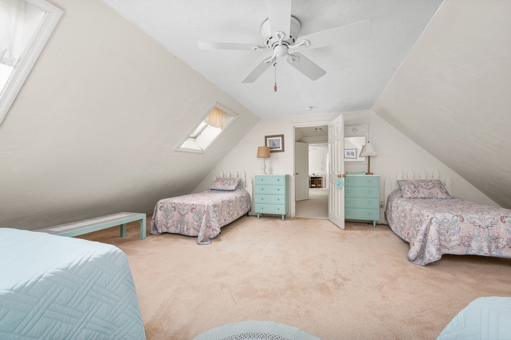 200 Sturbridge Drive Barnstable, MA 02655 - Photo 28 of 39 a spacious bedroom with a bed and a chandelier