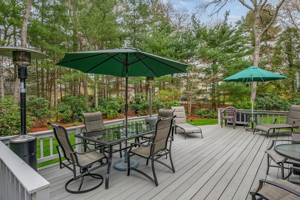 200 Sturbridge Drive Barnstable, MA 02655 - Photo 35 of 39 a view of a chairs and table under an umbrella in patio