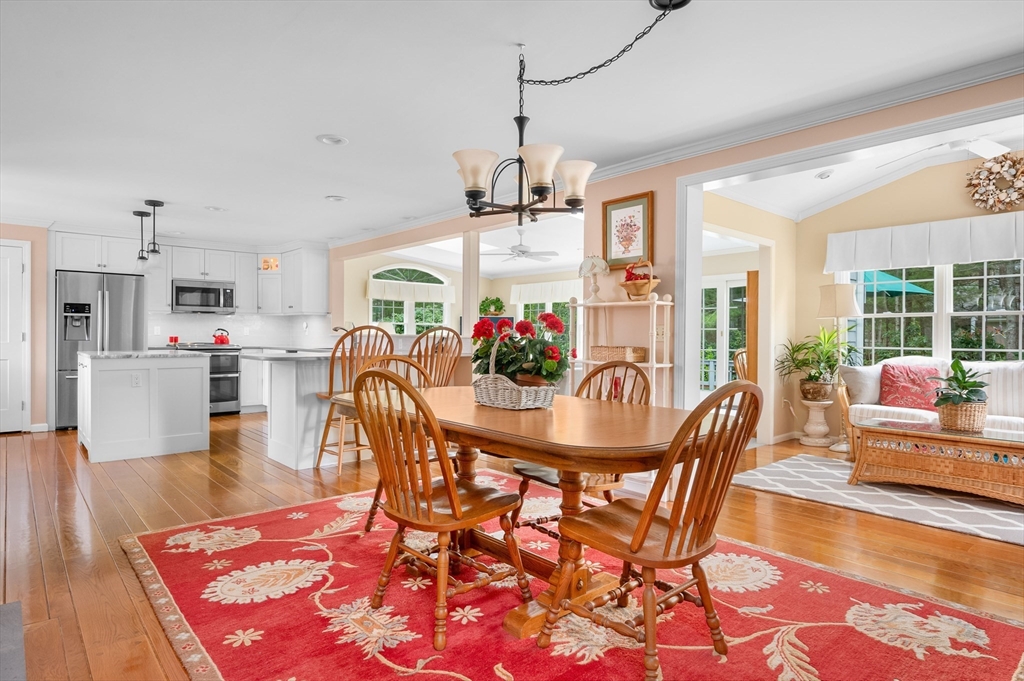 200 Sturbridge Drive Barnstable, MA 02655 - Photo 8 of 39 a dining room with furniture a chandelier and wooden floor