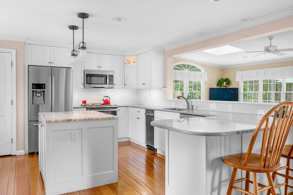 200 Sturbridge Drive Barnstable, MA 02655 - Photo 10 of 39 a kitchen with kitchen island granite countertop a sink center island and stainless steel appliances