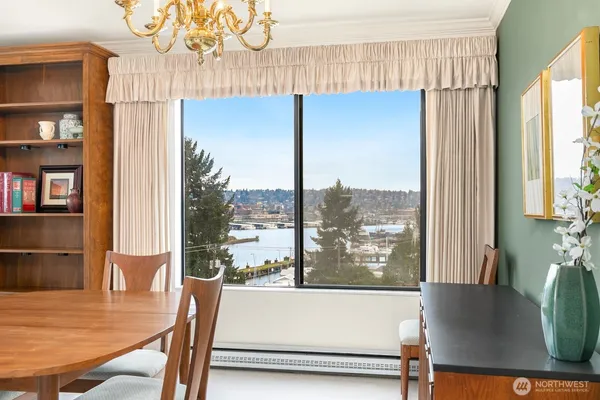 a living room with a table chairs and a large window