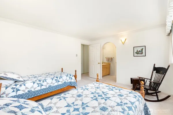 a bedroom with a bed and chair