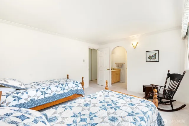 a bedroom with a bed and chair