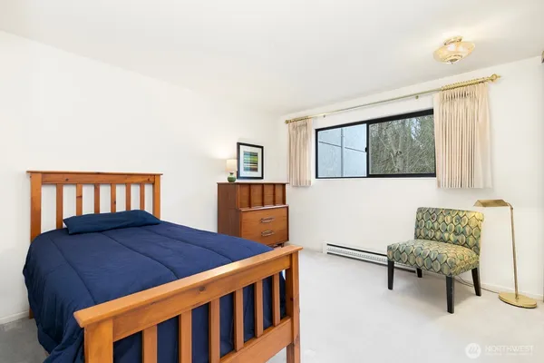 a bedroom with a bed and a couch in it