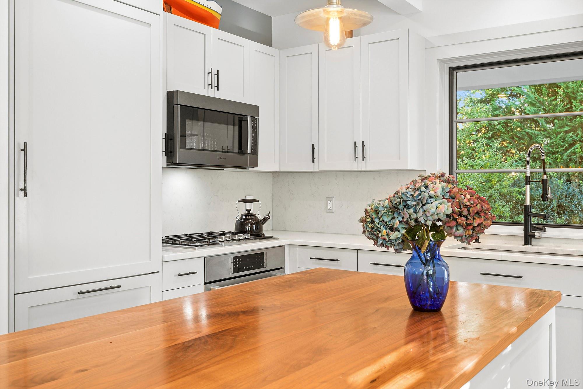 21 Cove Road Sag Harbor, NY 11963 - Photo 14 of 37 Kitchen with butcher block countertops, appliances with stainless steel finishes, and white cabinets